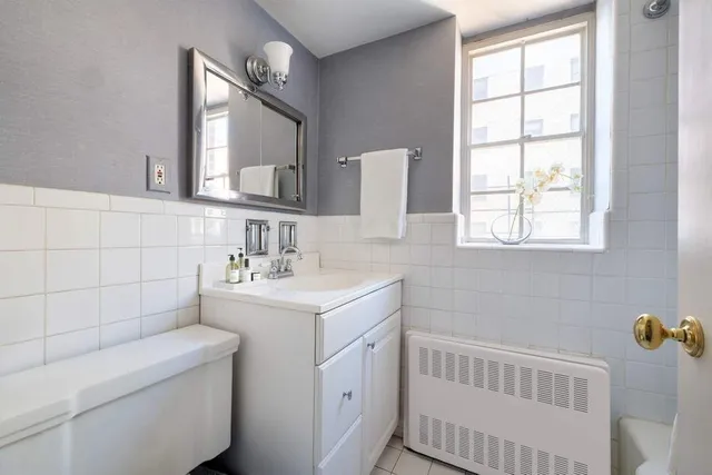 a spacious bedroom with a bed and a chandelier