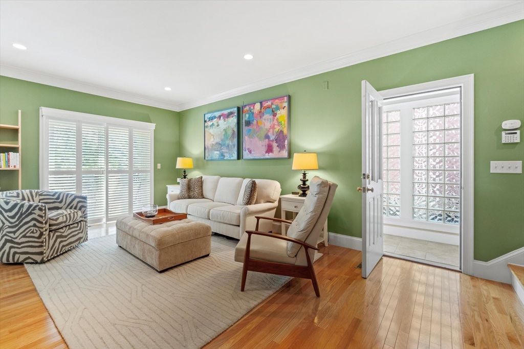 3 A Mill Street, Unit 3A Arlington, MA 02476 - Photo 12 of 38 a spacious bedroom with a bed a couch and a window