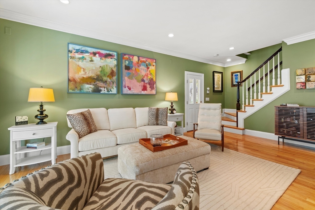 3 A Mill Street, Unit 3A Arlington, MA 02476 - Photo 16 of 38 a living room with furniture a rug and a wall painting