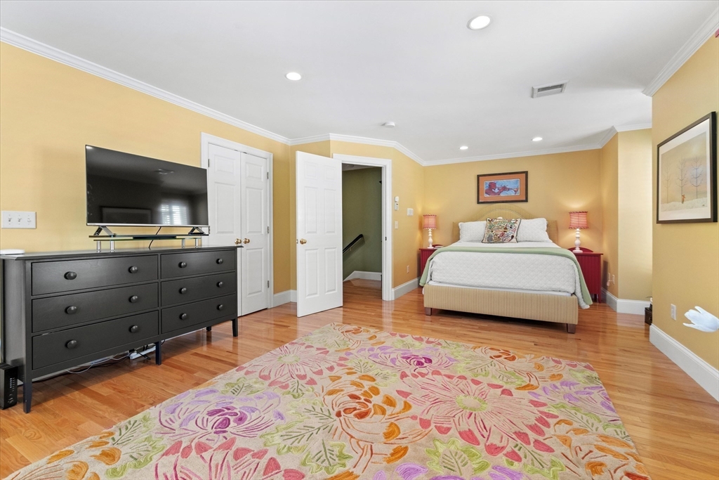 3 A Mill Street, Unit 3A Arlington, MA 02476 - Photo 18 of 38 a spacious bedroom with a bed and a flat screen tv