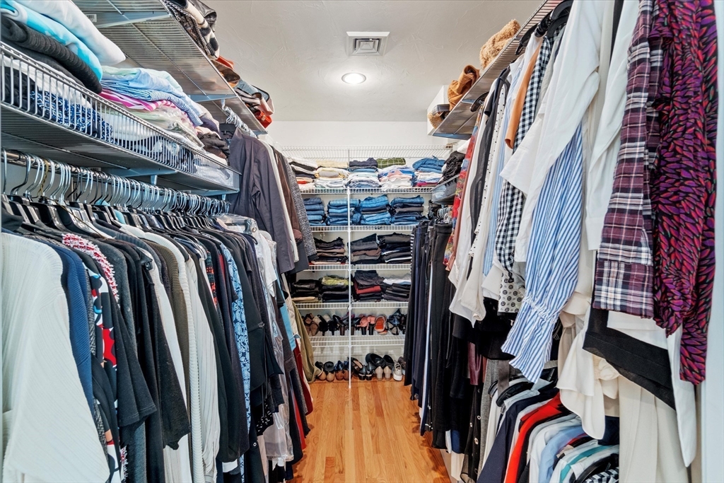 3 A Mill Street, Unit 3A Arlington, MA 02476 - Photo 19 of 38 a view of walk in closet with clothes and shoes
