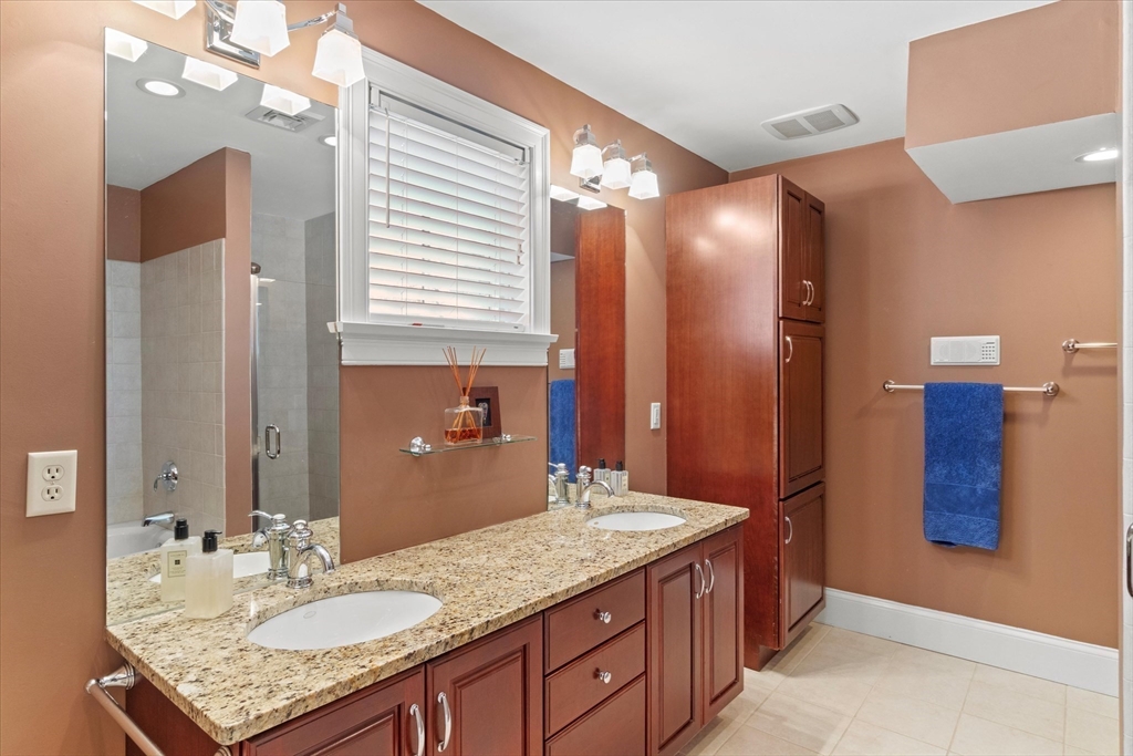 3 A Mill Street, Unit 3A Arlington, MA 02476 - Photo 22 of 38 a bathroom with a granite countertop sink and a mirror