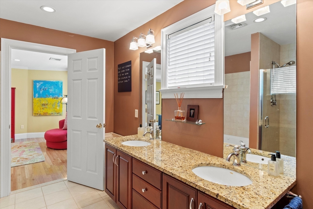3 A Mill Street, Unit 3A Arlington, MA 02476 - Photo 23 of 38 a bathroom with a granite countertop sink and a mirror