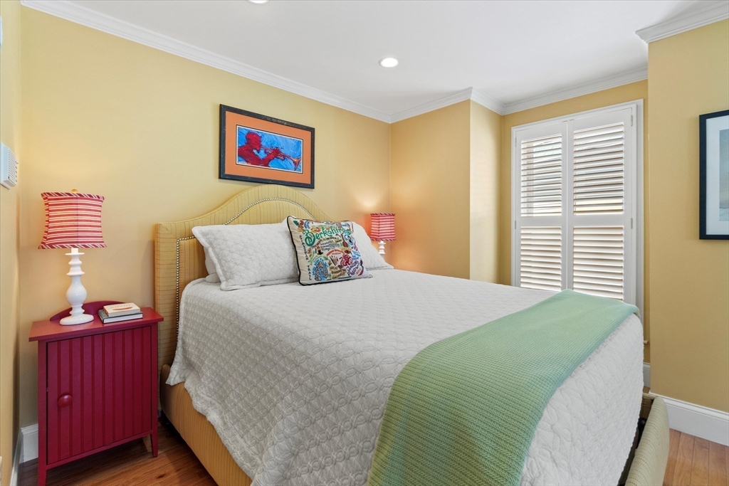 3 A Mill Street, Unit 3A Arlington, MA 02476 - Photo 25 of 38 a bedroom with a bed and wooden floor