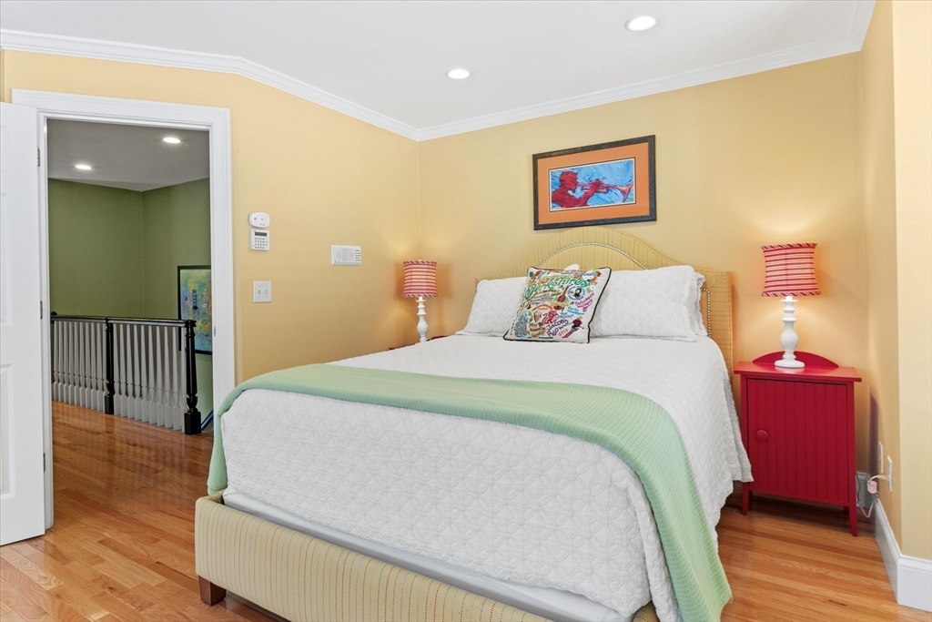 3 A Mill Street, Unit 3A Arlington, MA 02476 - Photo 26 of 38 a bedroom with a large bed and a chandelier