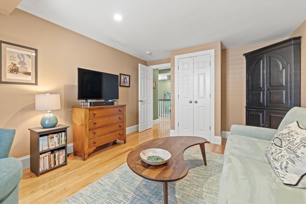 3 A Mill Street, Unit 3A Arlington, MA 02476 - Photo 32 of 38 a living room with furniture and a flat screen tv