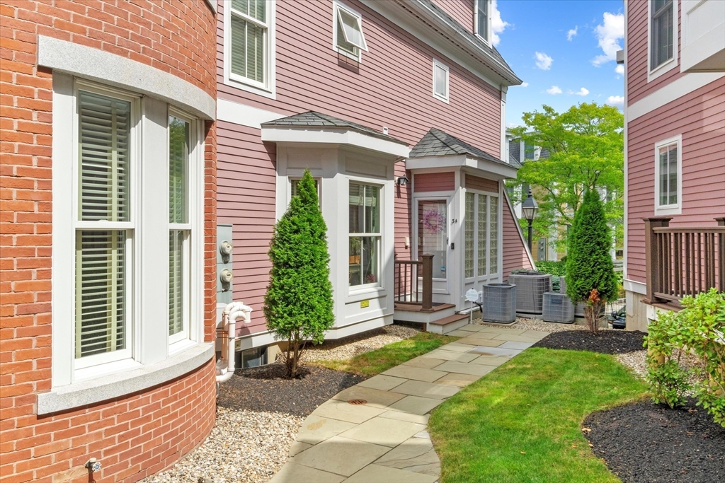 3 A Mill Street, Unit 3A Arlington, MA 02476 - Photo 4 of 38 a front view of a house with a yard