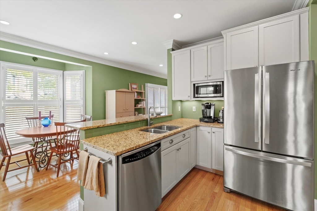 3 A Mill Street, Unit 3A Arlington, MA 02476 - Photo 6 of 38 a kitchen with stainless steel appliances granite countertop a refrigerator sink and stove