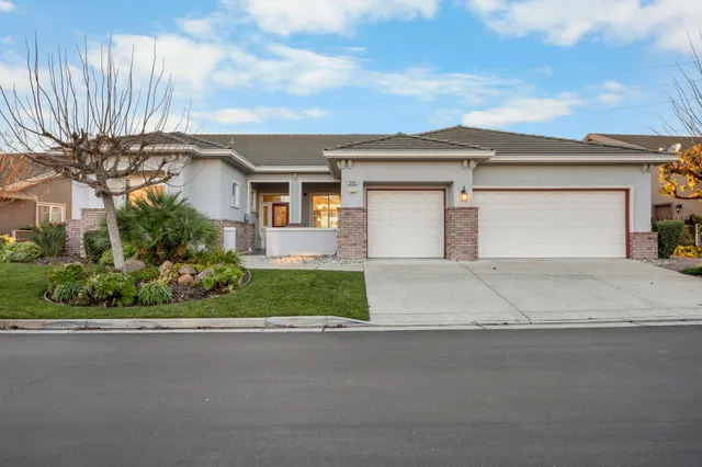 a front view of a house with a yard and garage