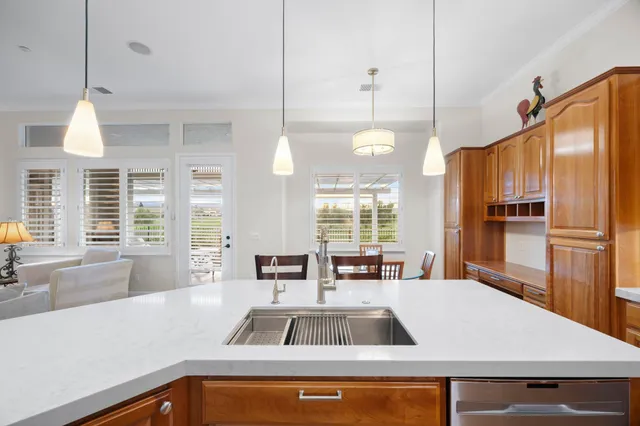 a bedroom with a bed a window and a chandelier