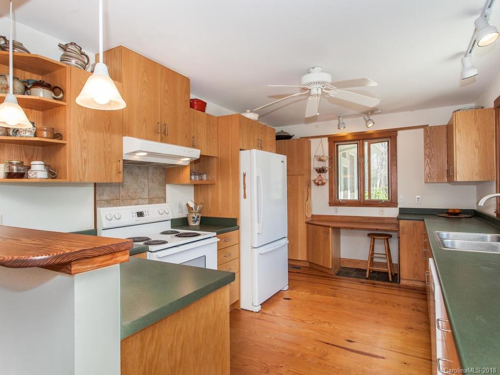 2831 Polk County Line Road Rutherfordton, NC 28139 - Photo 12 of 30 a kitchen with stainless steel appliances granite countertop a refrigerator a stove and a sink
