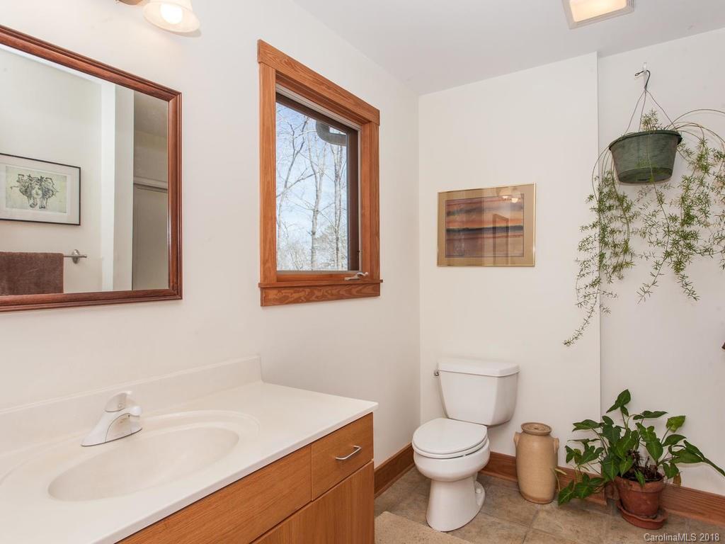 2831 Polk County Line Road Rutherfordton, NC 28139 - Photo 15 of 30 a bathroom with a toilet sink and mirror