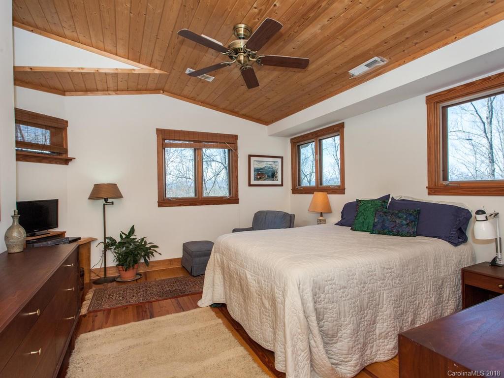 2831 Polk County Line Road Rutherfordton, NC 28139 - Photo 17 of 30 a bedroom with a balcony a bed and a chandelier