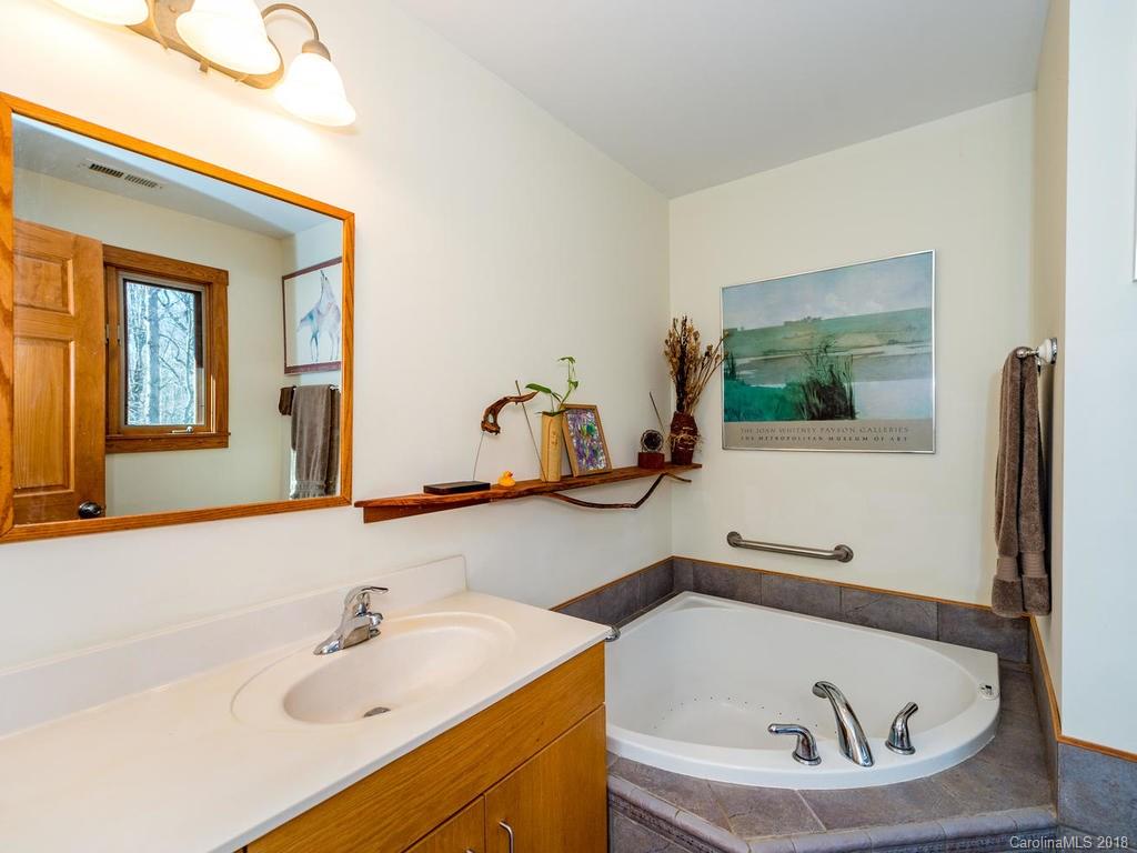 2831 Polk County Line Road Rutherfordton, NC 28139 - Photo 20 of 30 a bathroom with a tub sink and mirror