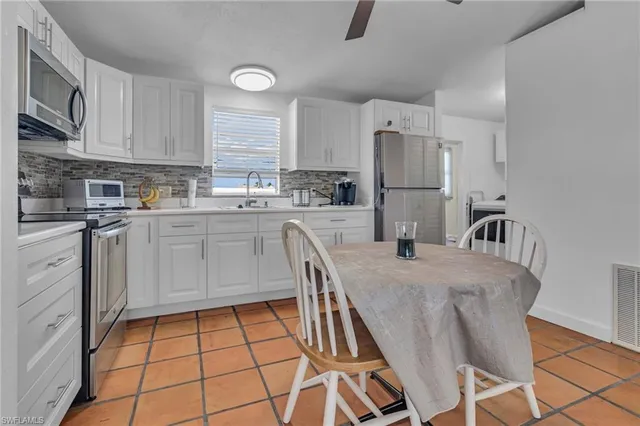 a view of washer and dryer with kitchen in the background