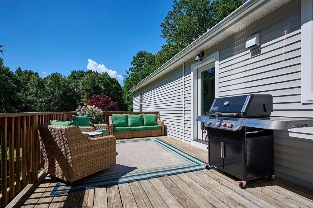 77 Reynolds Road Shelburne, MA 01370 - Photo 20 of 34 a view of a patio with table and chairs with wooden floor and fence