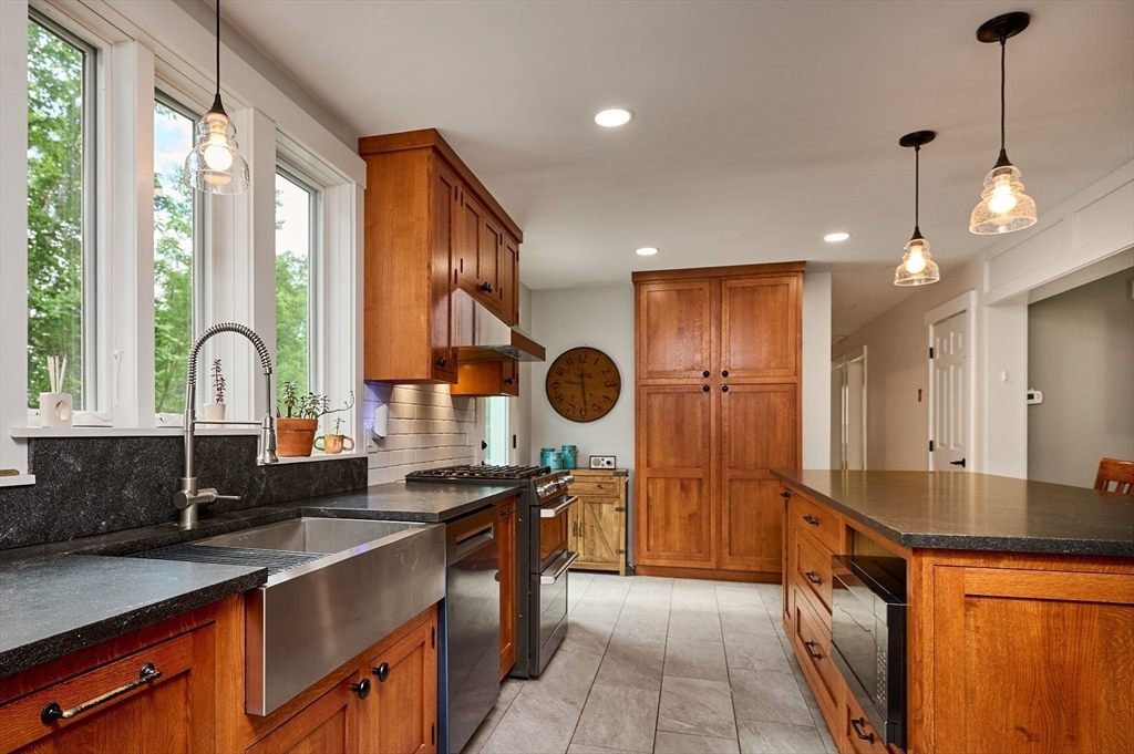 77 Reynolds Road Shelburne, MA 01370 - Photo 3 of 34 a kitchen with a sink stove and cabinets