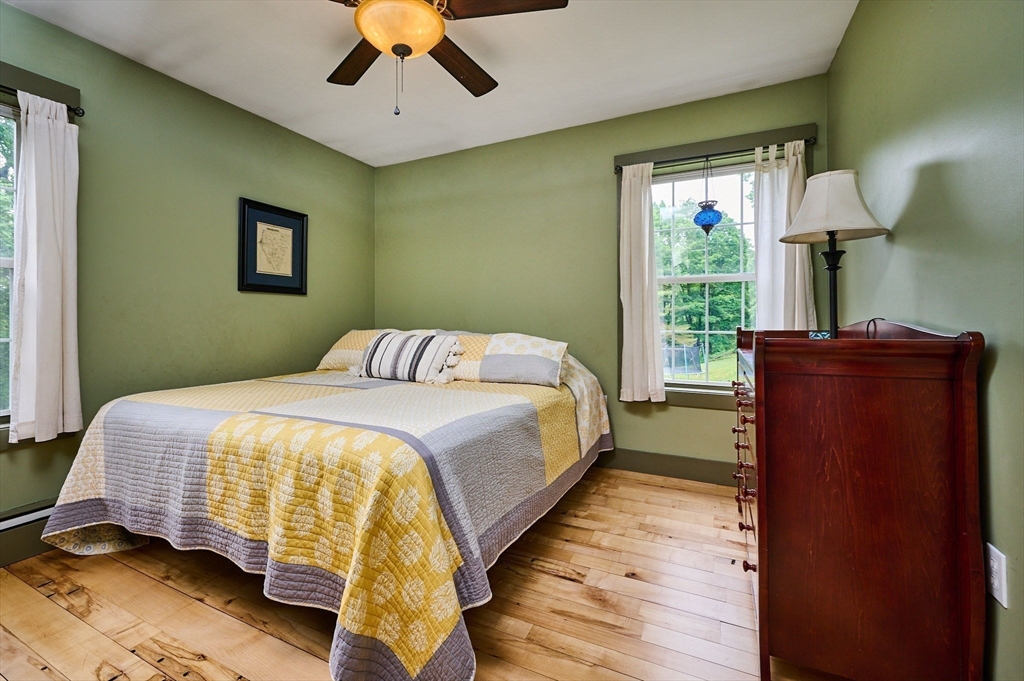 77 Reynolds Road Shelburne, MA 01370 - Photo 8 of 34 a bedroom with a bed and a potted plant