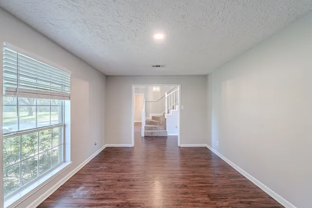 a view of wooden floor and a chandelier in closet