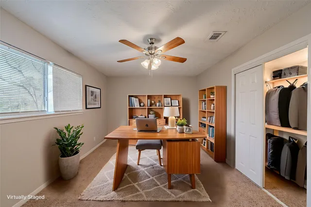 a large white kitchen with a sink and a large window