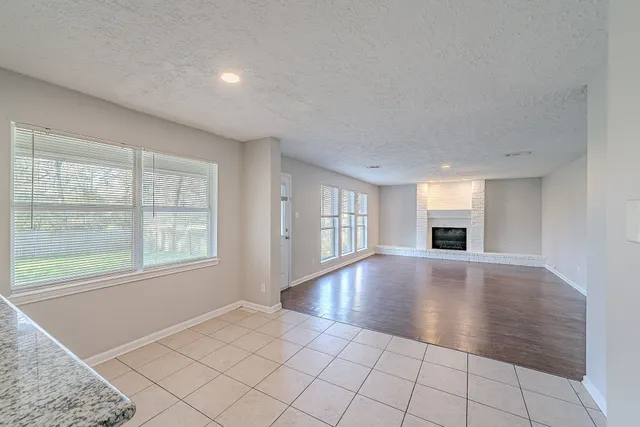 an empty room with windows and entrance