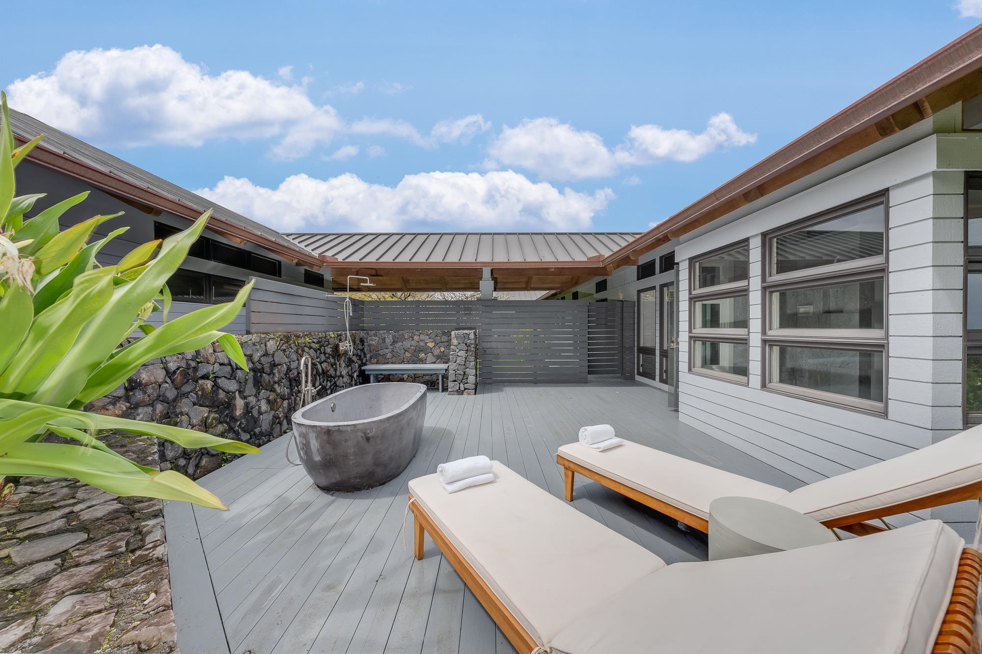 917 Hog Back Road Haiku, HI 96708 - Photo 13 of 30 a view of a patio with couches table and chairs and potted plants