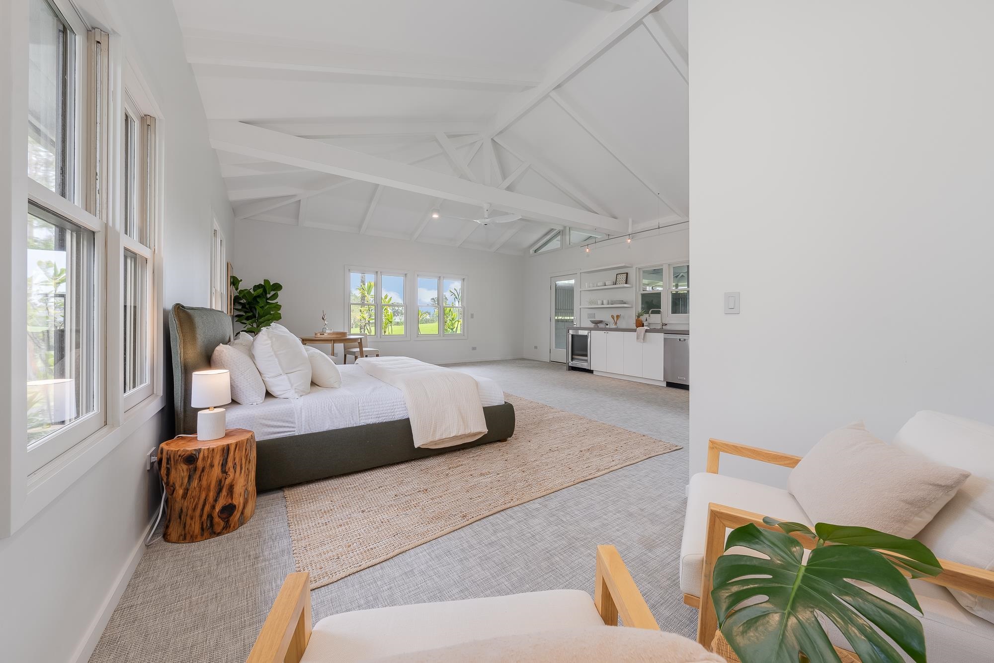 917 Hog Back Road Haiku, HI 96708 - Photo 24 of 30 a bedroom with furniture and a large window