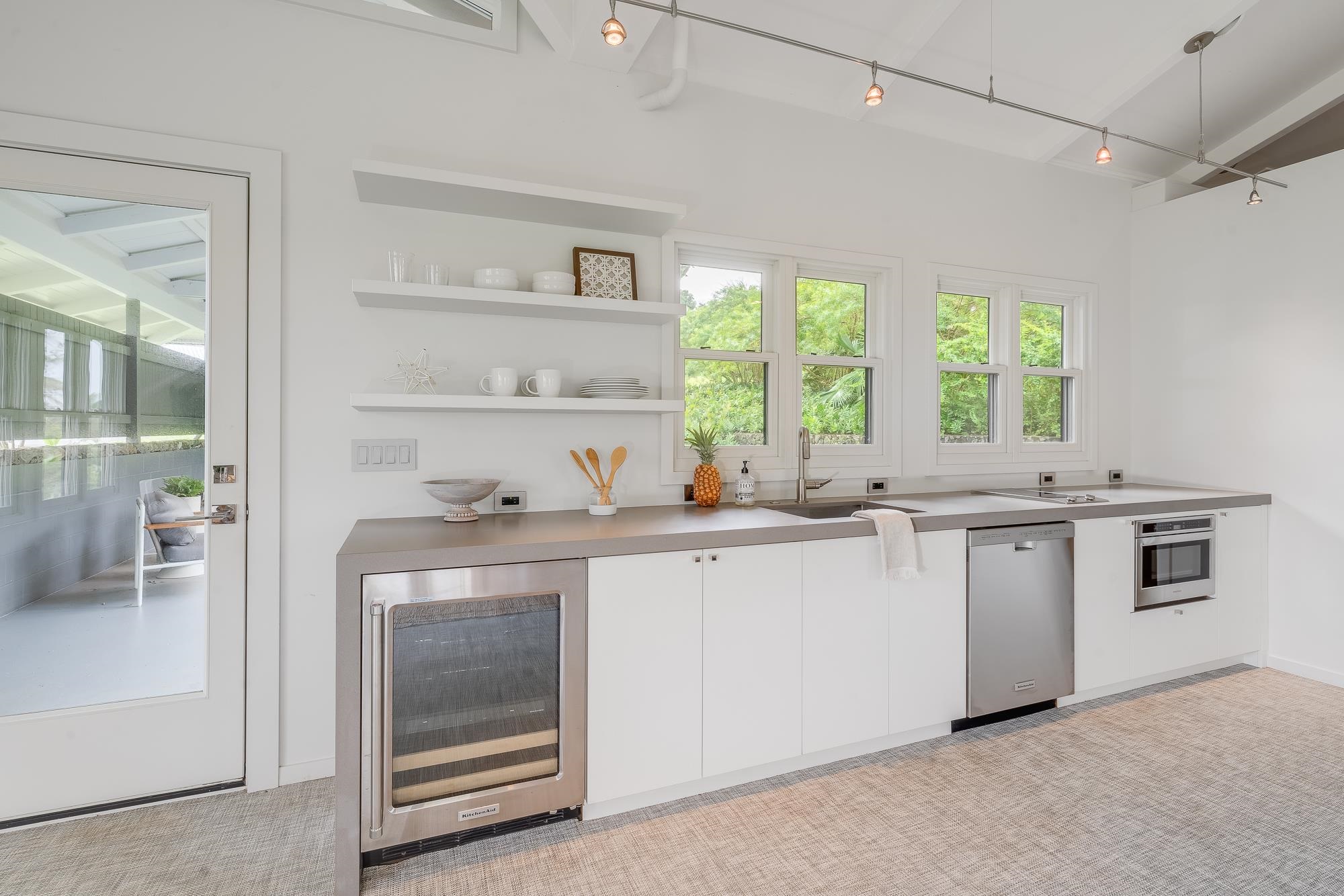 917 Hog Back Road Haiku, HI 96708 - Photo 25 of 30 a kitchen with a sink stove and cabinets