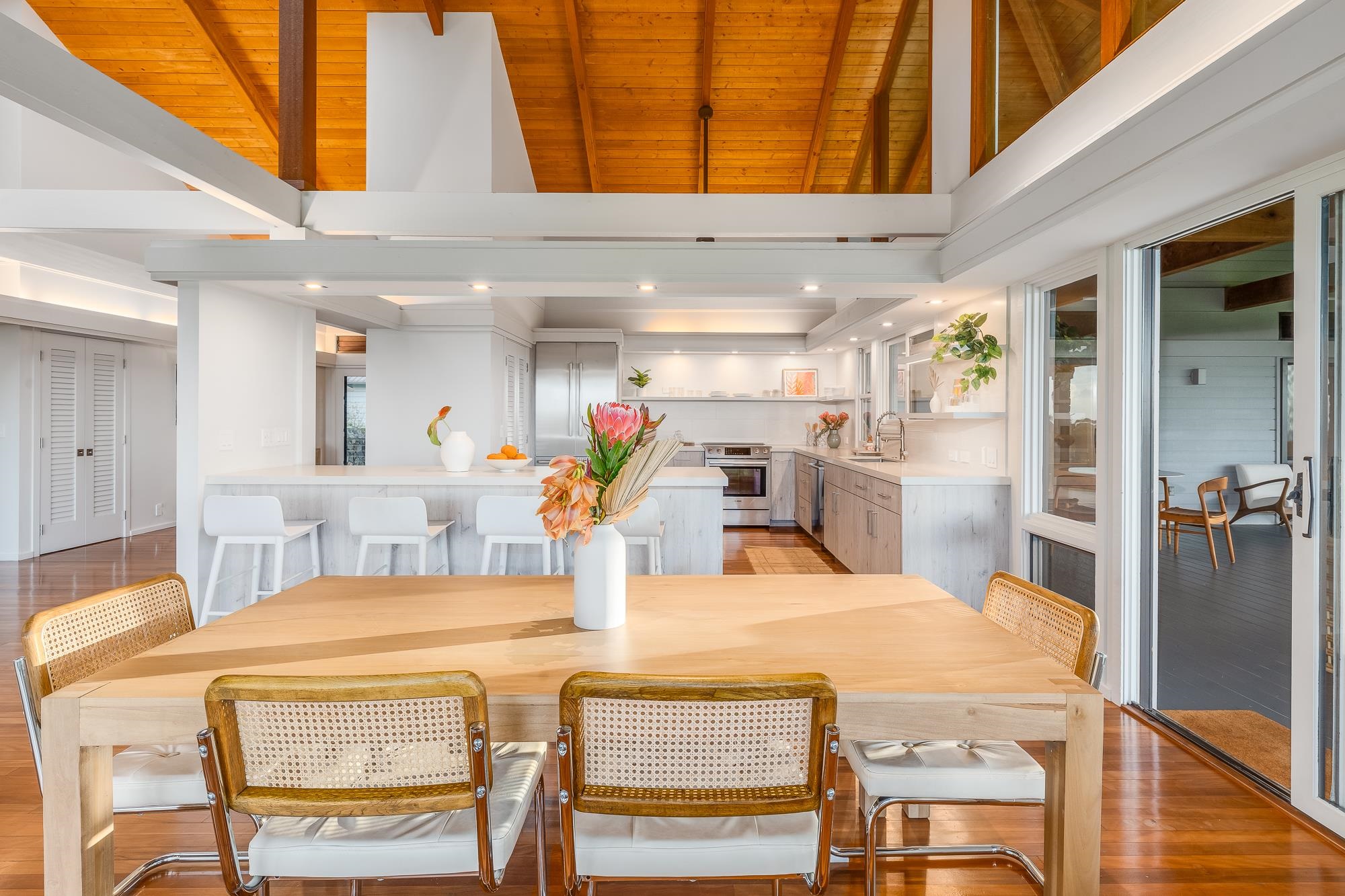 917 Hog Back Road Haiku, HI 96708 - Photo 7 of 30 a dining hall with a dining table chairs and chandelier