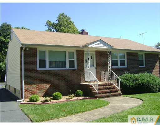 1437 Huron Road North Brunswick, NJ 08902 - Photo 1 of 11 a front view of a house with a garden