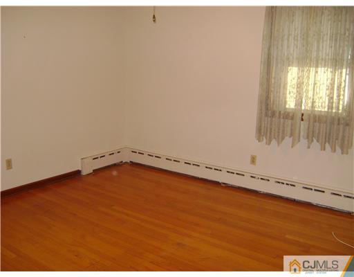 1437 Huron Road North Brunswick, NJ 08902 - Photo 5 of 11 a view of an empty room and window