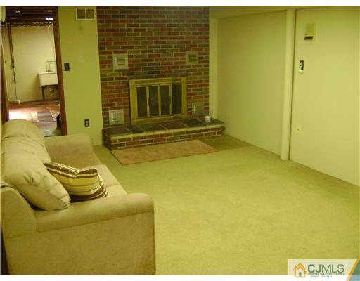 1437 Huron Road North Brunswick, NJ 08902 - Photo 6 of 11 a living room with a couch