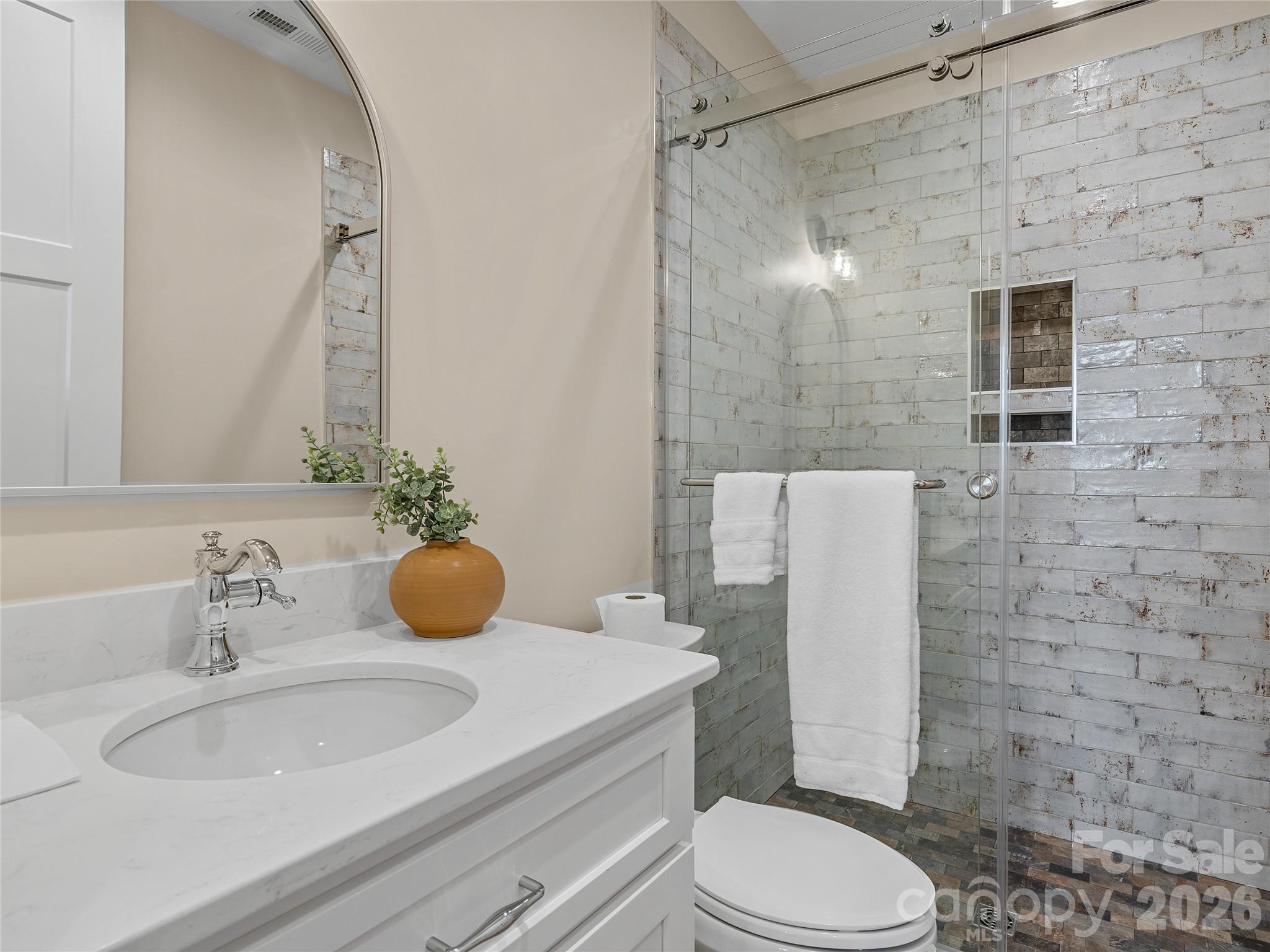 297 Mountain Meadows Lane, Unit 7 Tryon, NC 28782 - Photo 24 of 47 a bathroom with a sink toilet and shower