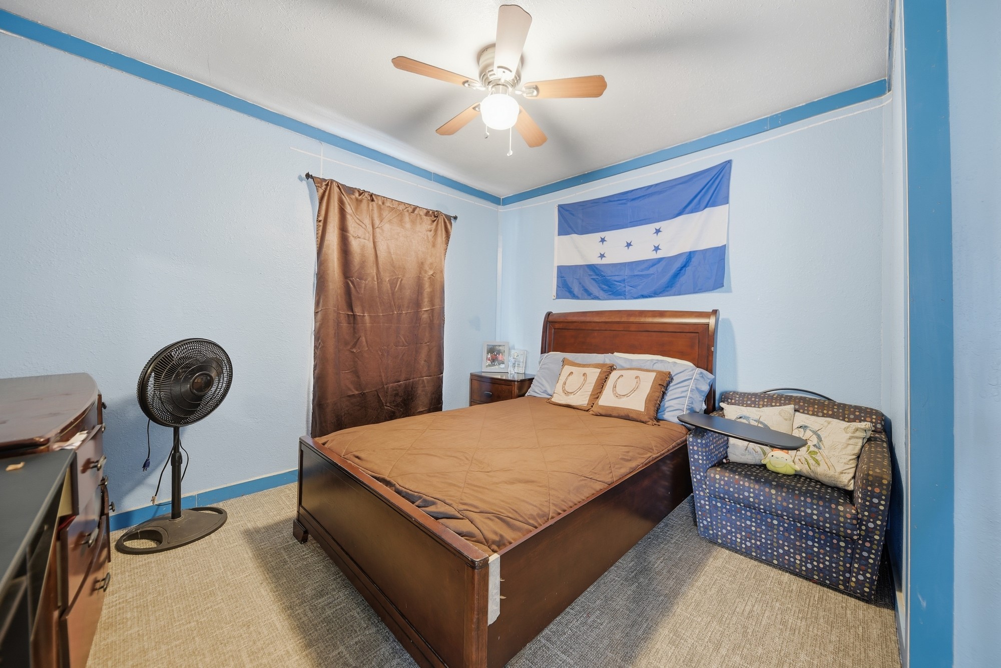 9524 Ferry Road Bellville, TX 77418 - Photo 6 of 15 a bedroom with a bed and a chandelier