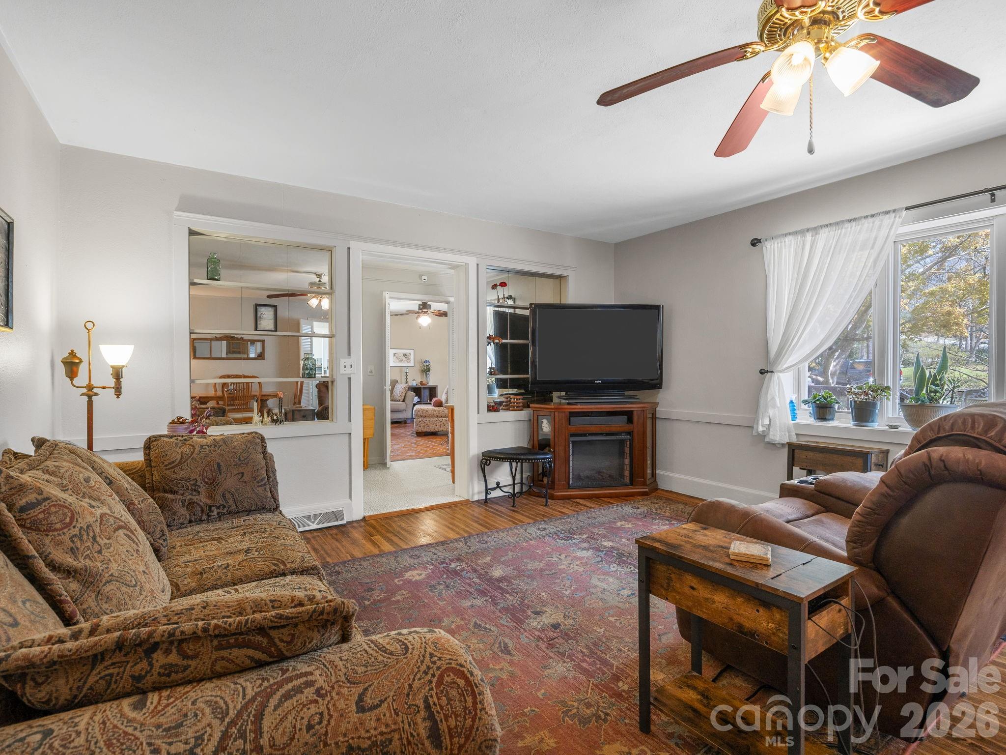 7 Rippy Road Tryon, NC 28782 - Photo 21 of 46 a living room with furniture and a flat screen tv with wooden floor