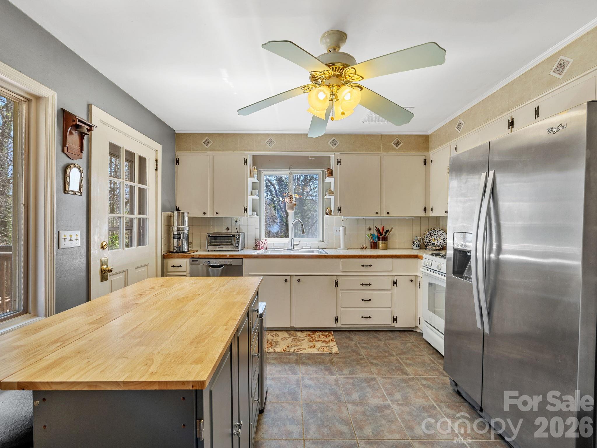 7 Rippy Road Tryon, NC 28782 - Photo 27 of 46 a kitchen with stainless steel appliances a stove a refrigerator and a sink