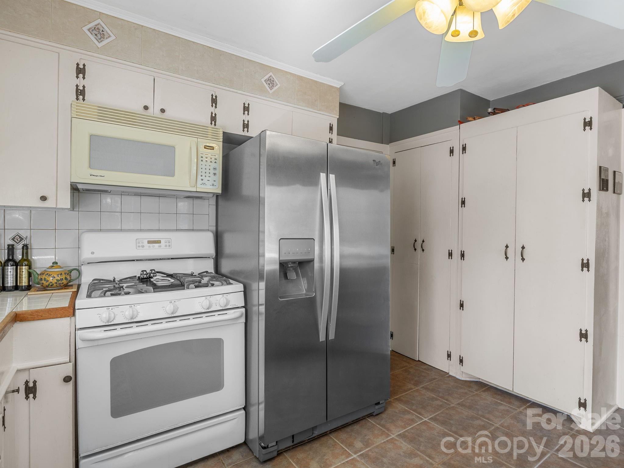 7 Rippy Road Tryon, NC 28782 - Photo 31 of 46 a kitchen with stainless steel appliances a stove a refrigerator and cabinets