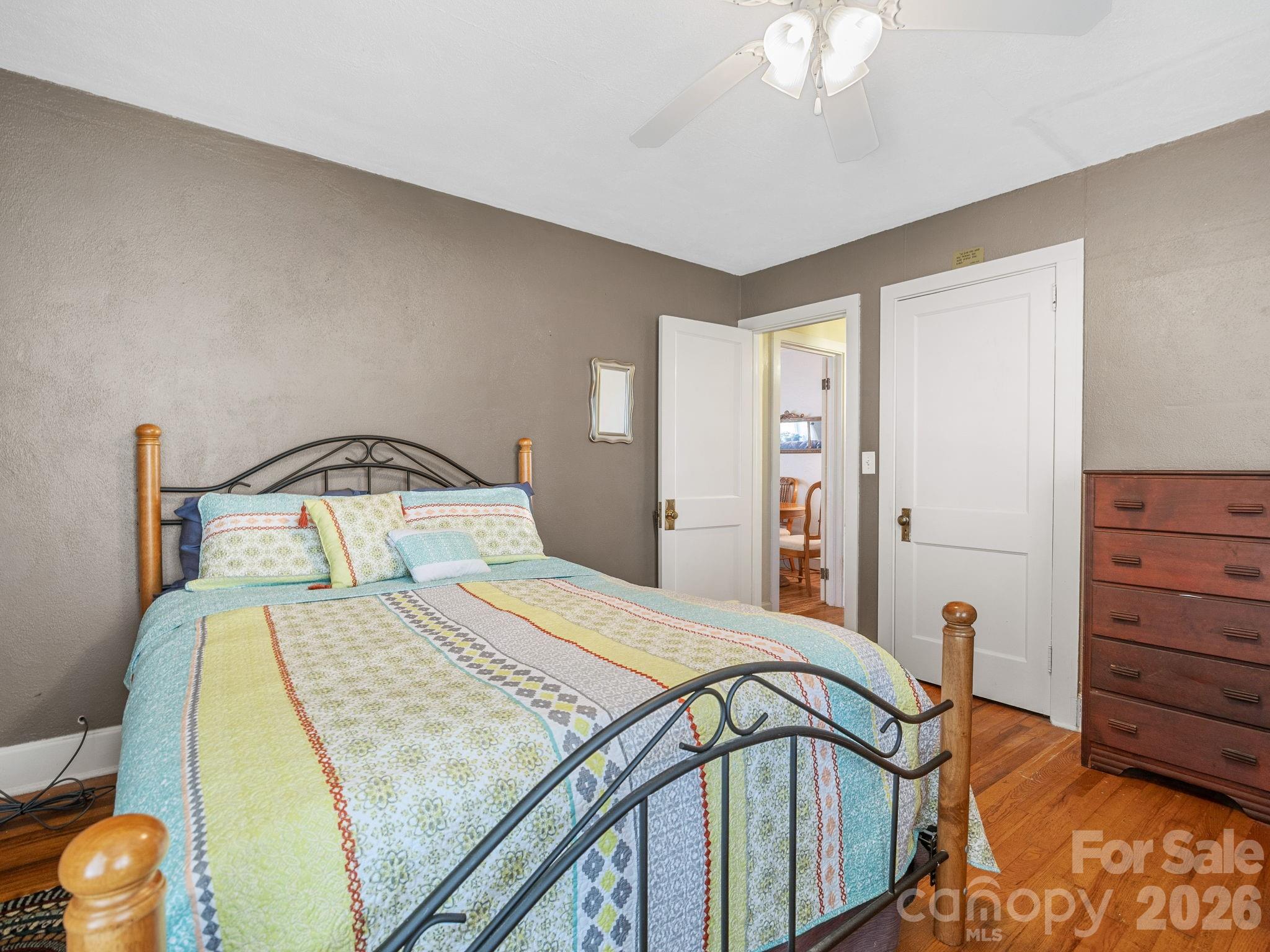 7 Rippy Road Tryon, NC 28782 - Photo 43 of 46 a bedroom with a bed and a chandelier