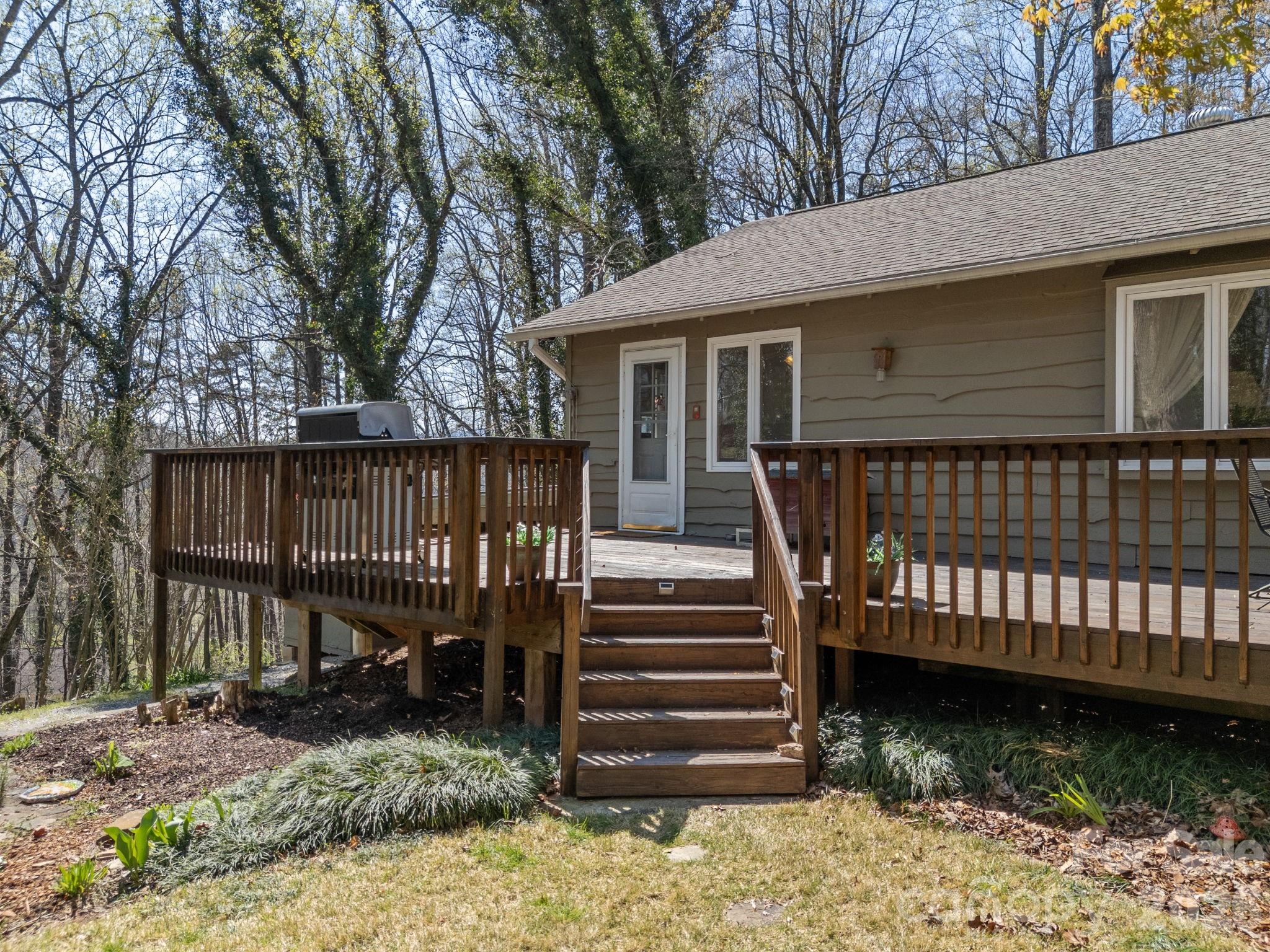 7 Rippy Road Tryon, NC 28782 - Photo 6 of 46 a view of a house with wooden deck next to a yard