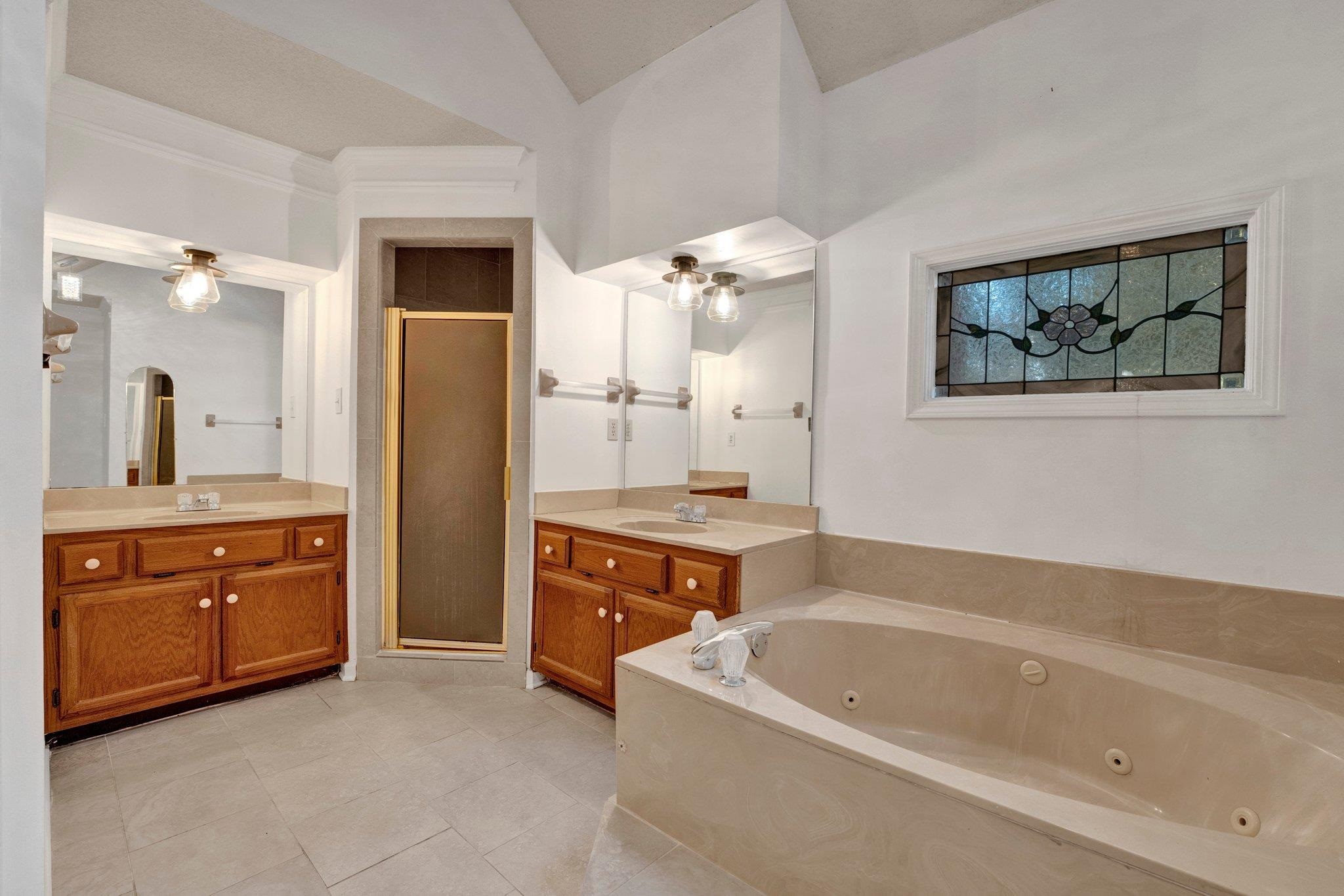 3656 Beaver Run Drive Collierville, TN 38017 - Photo 12 of 24 a bathroom with a tub a sink double vanity and a mirror