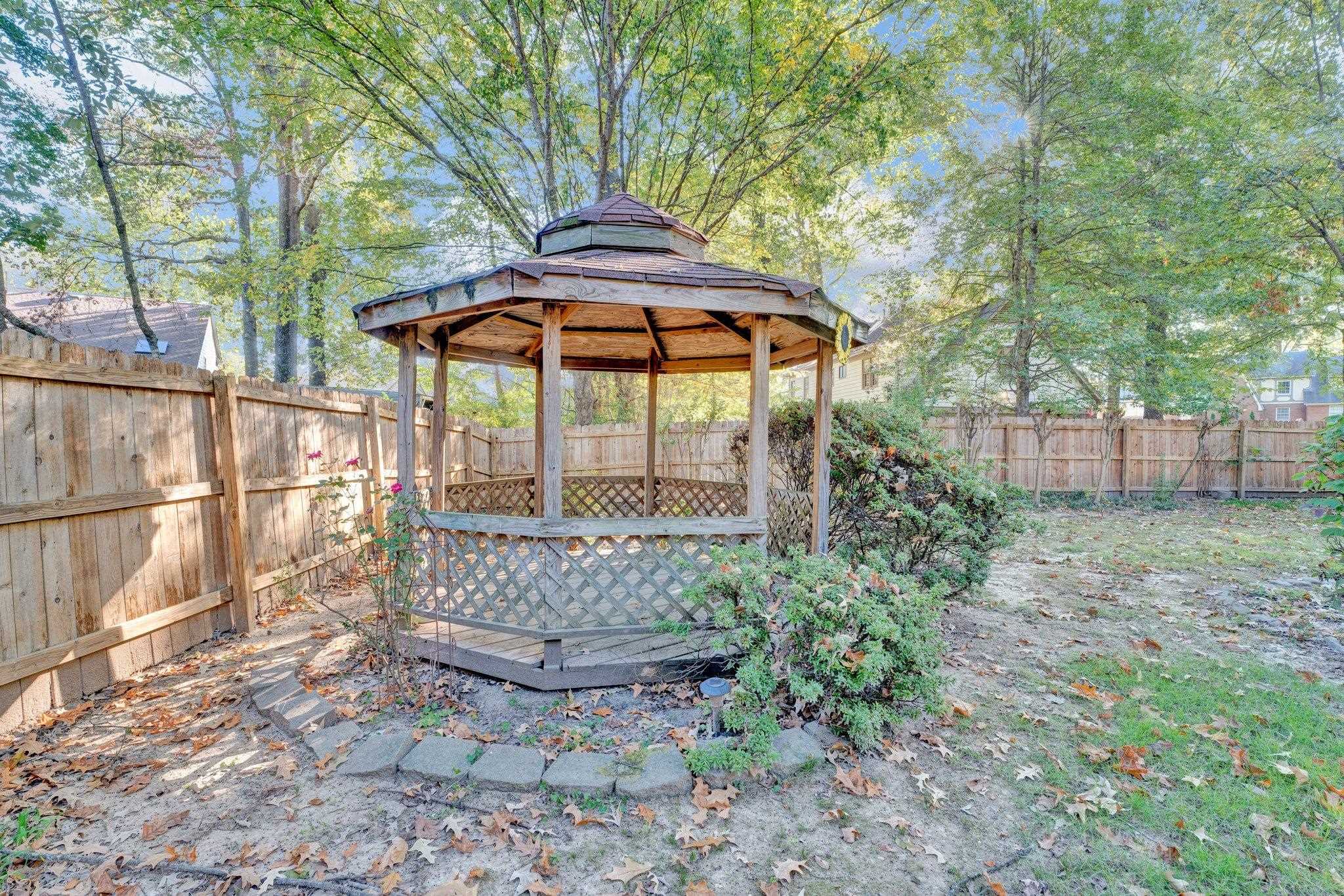 3656 Beaver Run Drive Collierville, TN 38017 - Photo 20 of 24 a view of a backyard with wooden fence and a large tree