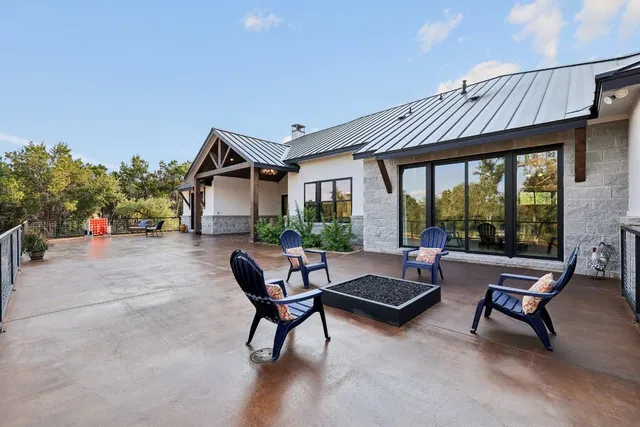 a view of a patio with a table and chairs