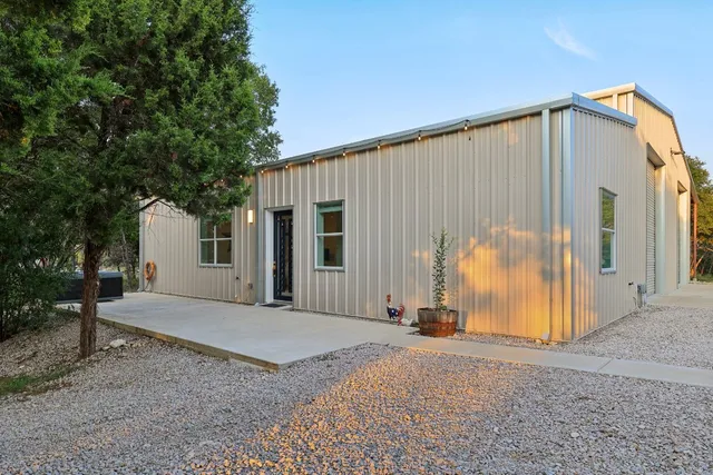 a view of a house with backyard and trees