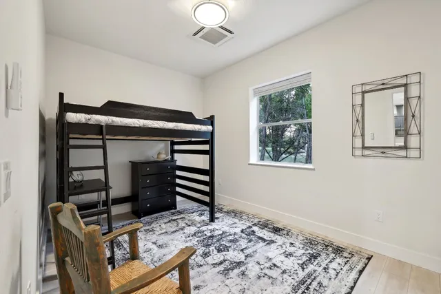 a bedroom with bed and a window