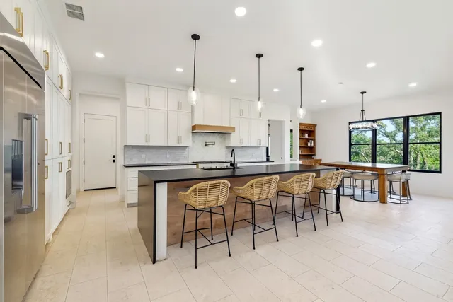 a large kitchen with a table and chairs