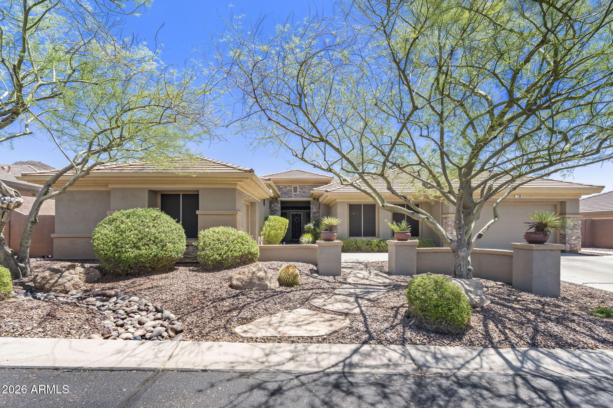 41619 North River Bend Road Anthem, AZ 85086 - Photo 7 of 84 a front view of a house with garden