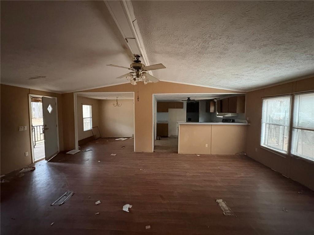 74 Davis Road Dawsonville, GA 30534 - Photo 3 of 6 a view of a livingroom with a kitchen and a stove