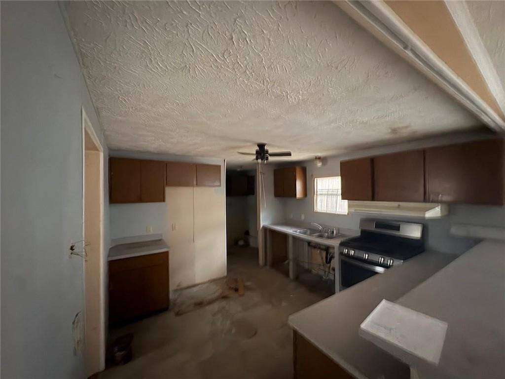 74 Davis Road Dawsonville, GA 30534 - Photo 5 of 6 a kitchen with kitchen island stainless steel appliances a sink stove and refrigerator