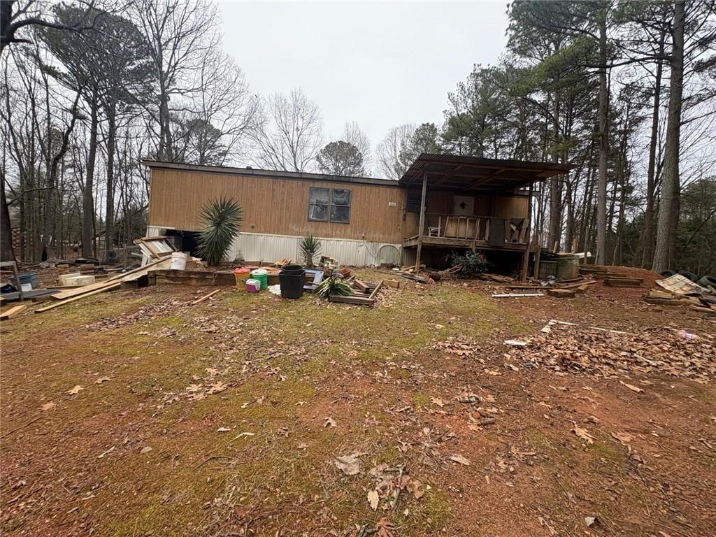 74 Davis Road Dawsonville, GA 30534 - Photo 6 of 6 a view of a backyard with table and chairs and a fire pit