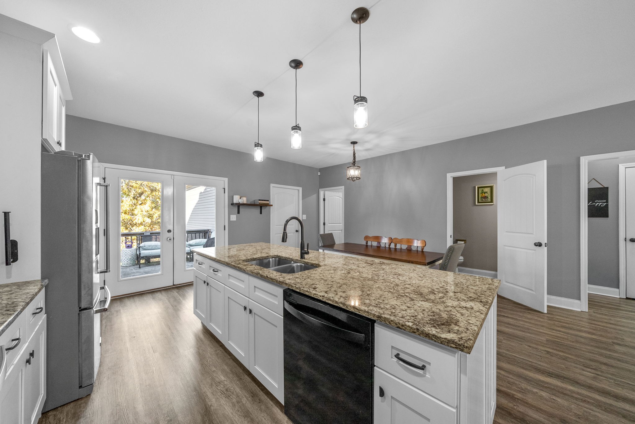 4553 Cumberland City Road Indian Mound, TN 37079 - Photo 15 of 44 a large kitchen with kitchen island a stove a sink a refrigerator and a wooden floor